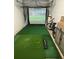 Fun indoor golf simulator setup on green flooring at 9208 Hillcroft Dr, Riverview, FL 33578