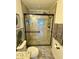 Shower features stylish tile, stone accents, and a seamless glass door at 9208 Hillcroft Dr, Riverview, FL 33578