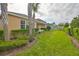 Well-maintained backyard, featuring manicured lawn and landscaping at 9244 Bella Vita Cir, Land O Lakes, FL 34637