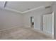 Spacious bedroom with neutral carpet, tray ceiling and ensuite bathroom entrance at 9244 Bella Vita Cir, Land O Lakes, FL 34637