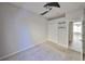 Bedroom featuring neutral carpet, ceiling fan and sliding door closet at 9244 Bella Vita Cir, Land O Lakes, FL 34637