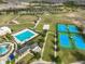 Aerial view of community amenities, including a pool, tennis courts, and recreational areas at 9244 Bella Vita Cir, Land O Lakes, FL 34637