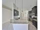 The kitchen features stainless steel appliances, dark wood cabinets, granite countertops, and tiled floors at 9244 Bella Vita Cir, Land O Lakes, FL 34637