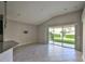 Bright living room featuring tile floors and a large sliding glass door to the backyard at 9244 Bella Vita Cir, Land O Lakes, FL 34637