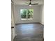 Bright bedroom featuring a ceiling fan, large windows, and vinyl flooring at 10351 Regal Dr # 10, Largo, FL 33774