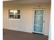 Image shows exterior front door to unit 10 with a window to the left at 10351 Regal Dr # 10, Largo, FL 33774