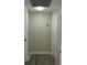 Clean hallway features modern gray laminate flooring, neutral paint, and white trim at 10351 Regal Dr # 10, Largo, FL 33774