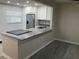 Well-lit kitchen with granite counters, stainless appliances, and vinyl floors overlooking living area at 10351 Regal Dr # 10, Largo, FL 33774