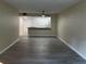 Open living room area with vinyl flooring, neutral paint, and easy access to kitchen at 10351 Regal Dr # 10, Largo, FL 33774