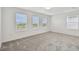 Bright bedroom featuring neutral walls, plush carpeting, and several windows allowing natural light at 10352 Cross River Trl, Parrish, FL 34219