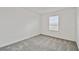 Bright bedroom featuring neutral walls, plush carpeting, and a window allowing natural light at 10352 Cross River Trl, Parrish, FL 34219