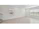 Empty bonus room with lots of natural light, tile floor, and stairs at 10352 Cross River Trl, Parrish, FL 34219