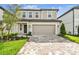 Charming two-story home with a two-car garage, brick paver driveway and manicured landscaping at 10352 Cross River Trl, Parrish, FL 34219