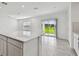 Open-concept kitchen with a large island, sleek cabinets, and a seamless transition to the outdoor living space at 10352 Cross River Trl, Parrish, FL 34219