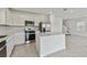Modern kitchen featuring stainless steel appliances, quartz countertops and center island at 10352 Cross River Trl, Parrish, FL 34219
