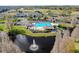 Overhead shot of the community pool area with a fountain pond, cabana, and surrounding green space at 10736 Keys Gate Dr, Riverview, FL 33579