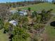 Aerial view of the property highlighting the house, pool, outbuilding, and surrounding landscape at 10925 Fort King Rd, Dade City, FL 33525