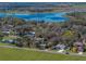 An aerial view highlights the property's location near a beautiful lake, complemented by lush greenery and clear skies at 10925 Fort King Rd, Dade City, FL 33525