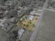 An aerial view showcases a property with a screened pool, surrounded by lush greenery in a residential neighborhood at 10925 Fort King Rd, Dade City, FL 33525