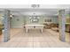 Large open basement featuring tile floors, pool table and comfortable seating area at 10925 Fort King Rd, Dade City, FL 33525