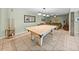 Basement featuring tile floors, a pool table, comfortable seating area, and unique design elements at 10925 Fort King Rd, Dade City, FL 33525