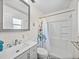 Bright bathroom features a modern vanity, shower-tub combo, and patterned tile floor at 10925 Fort King Rd, Dade City, FL 33525