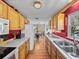 Galley kitchen featuring ample cabinets, laminate countertops, and an adjacent dining area at 10925 Fort King Rd, Dade City, FL 33525