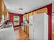 Traditional-style kitchen features wood cabinets, white appliances, and ample counter space at 10925 Fort King Rd, Dade City, FL 33525
