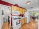 Cozy kitchen features wood cabinetry and white appliances, perfect for home-cooked meals at 10925 Fort King Rd, Dade City, FL 33525
