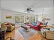Inviting living room and dining area with hardwood floors, large windows, and comfortable seating arrangements at 10925 Fort King Rd, Dade City, FL 33525