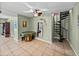 Open living space featuring tile floors, a ceiling fan, and a unique spiral staircase at 10925 Fort King Rd, Dade City, FL 33525