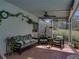 Relaxing screened-in patio with comfortable seating and decorative plants at 10925 Fort King Rd, Dade City, FL 33525
