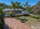 Bask in outdoor bliss with a screened pool and palm trees, perfect for relaxation and entertaining at 10925 Fort King Rd, Dade City, FL 33525
