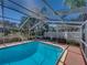 Relax in this inviting screened-in private pool with an extended outdoor seating area at 10925 Fort King Rd, Dade City, FL 33525