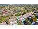 An aerial view shows homes surrounded by golf course, tennis courts, and lush greenery at 12407 Eagleswood Dr # C, Hudson, FL 34667