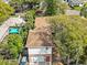 An aerial view showcases the property's roof, landscaping, and proximity to nearby homes and neighborhood streets at 1520 15Th N St, St Petersburg, FL 33704