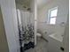 Bathroom with a shower, toilet, single vanity, and a window for natural light at 1520 15Th N St, St Petersburg, FL 33704