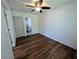 Bedroom with ceiling fan, wood floors, white walls, closet and an ensuite bathroom at 1520 15Th N St, St Petersburg, FL 33704