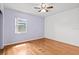This bedroom features hardwood floors, a ceiling fan, and a window for natural light at 1520 15Th N St, St Petersburg, FL 33704