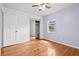This bedroom features hardwood floors, a ceiling fan, a window for natural light, and a closet with mirrored doors at 1520 15Th N St, St Petersburg, FL 33704