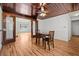 Dining room features hardwood floors, dark wood trim, and a ceiling fan at 1520 15Th N St, St Petersburg, FL 33704