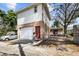 Exterior view of the two-story home with garage and small yard behind a chain-link fence at 1520 15Th N St, St Petersburg, FL 33704