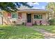 Charming home exterior featuring a cozy porch, landscaped yard and decorative shutters at 1520 15Th N St, St Petersburg, FL 33704