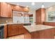 Kitchen with granite countertops, stainless steel appliances, wood cabinets, and tiled floors at 1520 15Th N St, St Petersburg, FL 33704