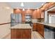 Kitchen featuring granite counters, stainless steel appliances, wood cabinets and a center island at 1520 15Th N St, St Petersburg, FL 33704