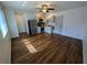 Open-concept living space featuring wood floors and a ceiling fan adjacent to the kitchen with stainless steel appliances at 1520 15Th N St, St Petersburg, FL 33704