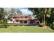 Exterior showcasing a two-story home with a pool and generous green backyard at 1550 Chateau Wood Dr, Clearwater, FL 33764