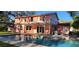A lovely backyard with a sparkling swimming pool and an outdoor patio area perfect for entertaining at 1550 Chateau Wood Dr, Clearwater, FL 33764