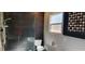 Bathroom featuring a tiled shower, standard toilet, and a frosted window at 1550 Chateau Wood Dr, Clearwater, FL 33764