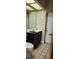 Small bathroom with a vanity, toilet and large mirror at 1550 Chateau Wood Dr, Clearwater, FL 33764
